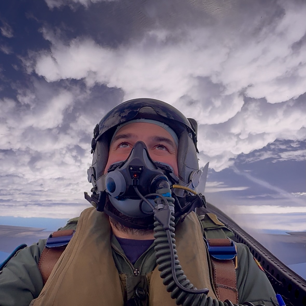 Self-portrait in the cockpit, oxygen mask on, level flight